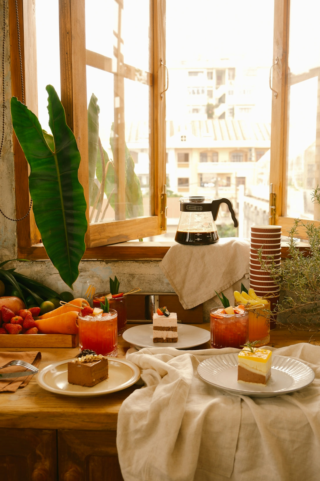 a table topped with plates of food next to a window