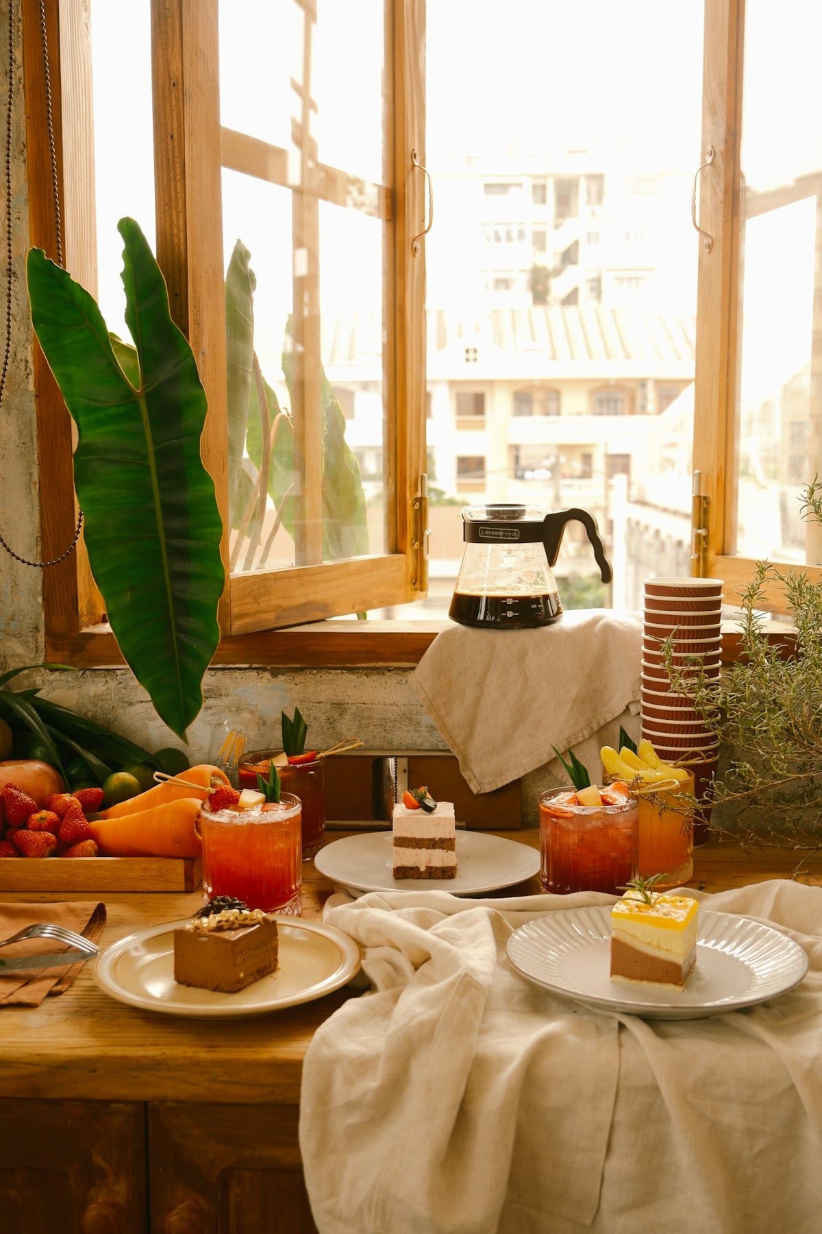 a table topped with plates of food next to a window