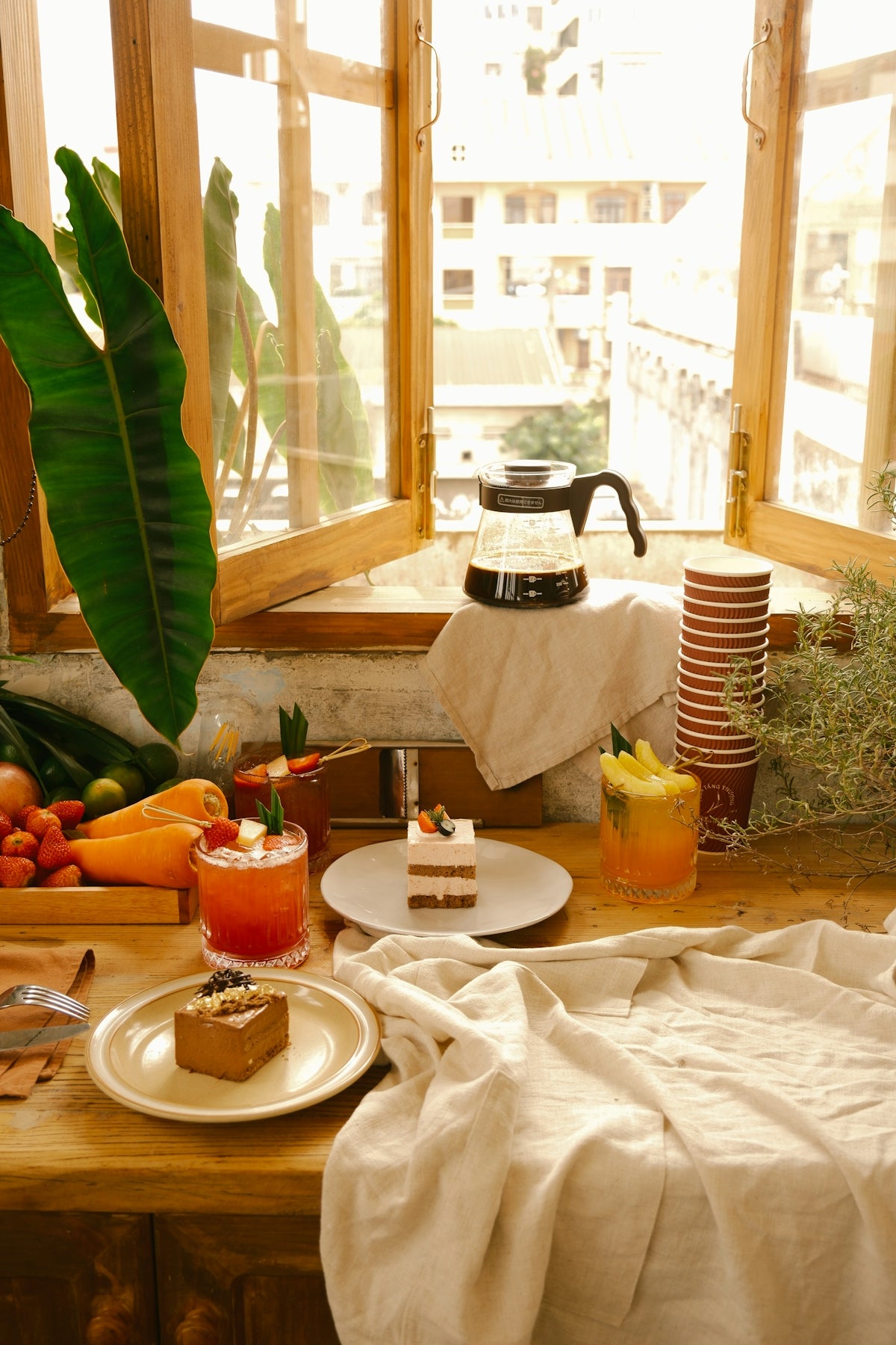 a wooden table topped with plates of food