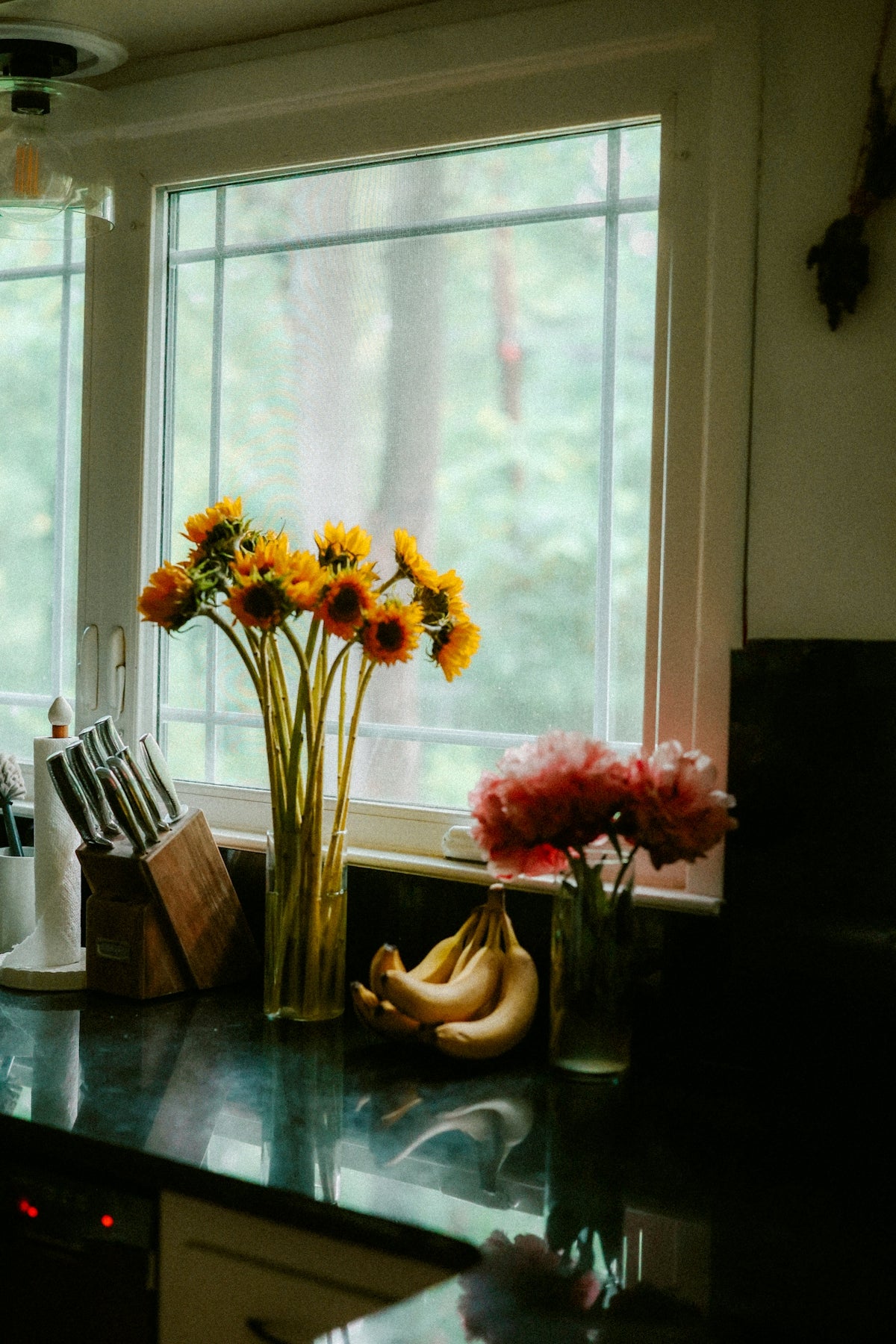 Sunflowers and bananas brighten a kitchen windowsill