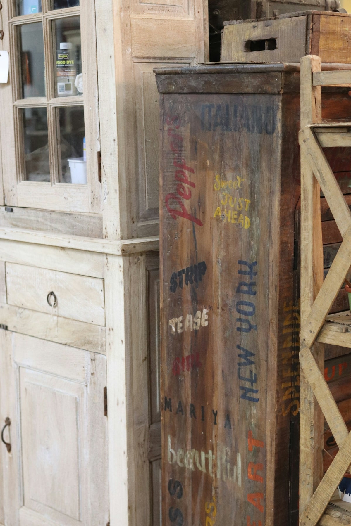 Wooden cabinet with painted lettering and antique furniture